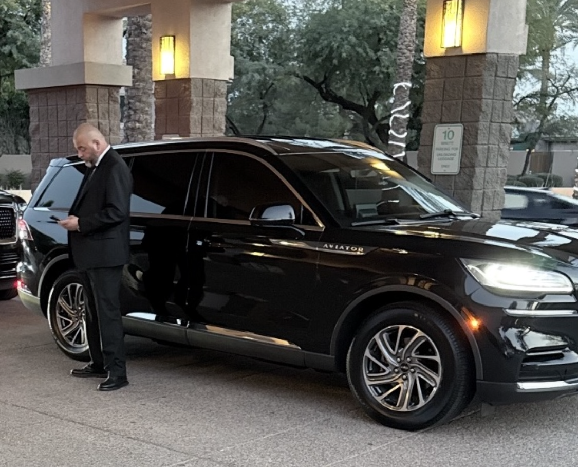 Chauffeur opening Lincoln Aviator door